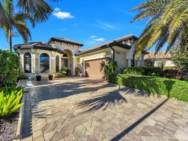 mediterranean / spanish-style house with a garage