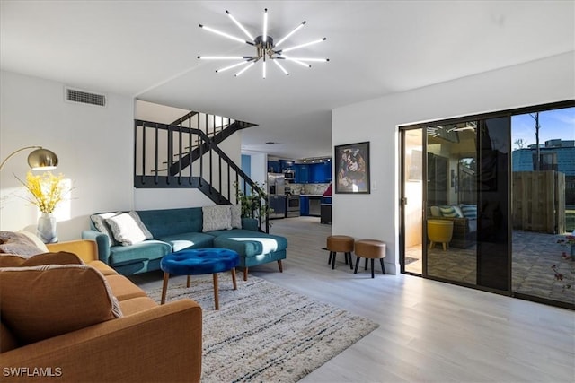 5570 Woodrose Ct Unit 2, Fort Myers, FL 33907 - living room with wood finished floors, stairway, and a chandelier