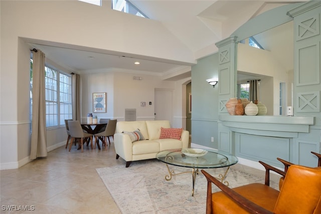 living room with crown molding and a towering ceiling