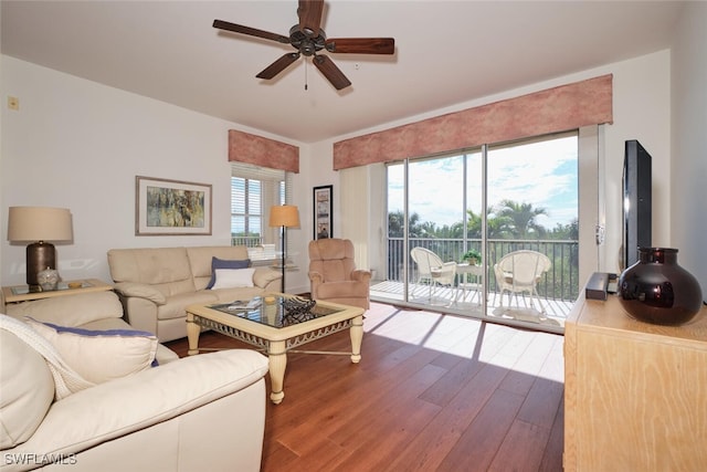 living room with hardwood / wood-style floors and ceiling fan