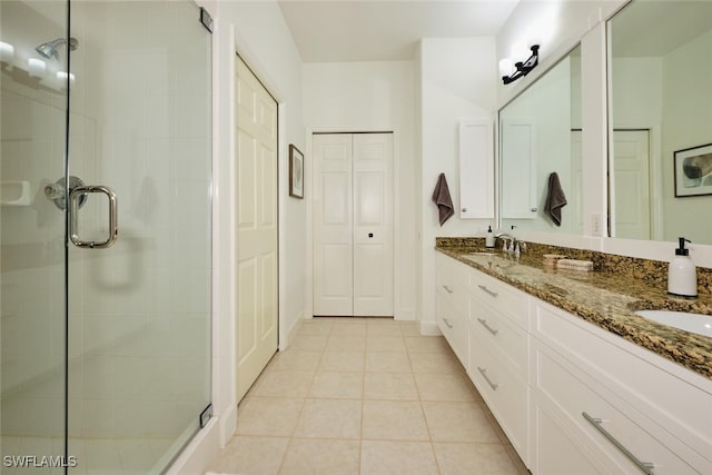 bathroom featuring walk in shower, vanity, and tile patterned flooring