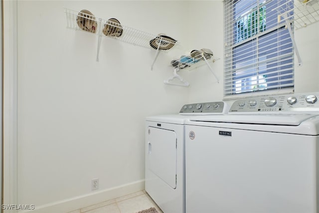 laundry area featuring light tile patterned floors and washer and dryer