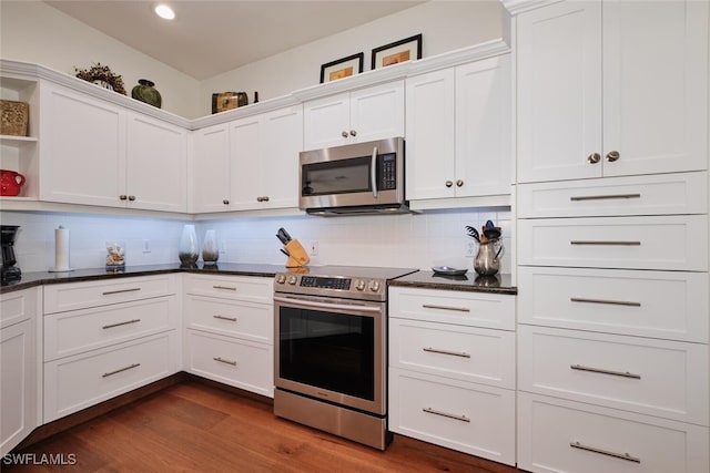 kitchen featuring backsplash, appliances with stainless steel finishes, dark wood-type flooring, and white cabinets