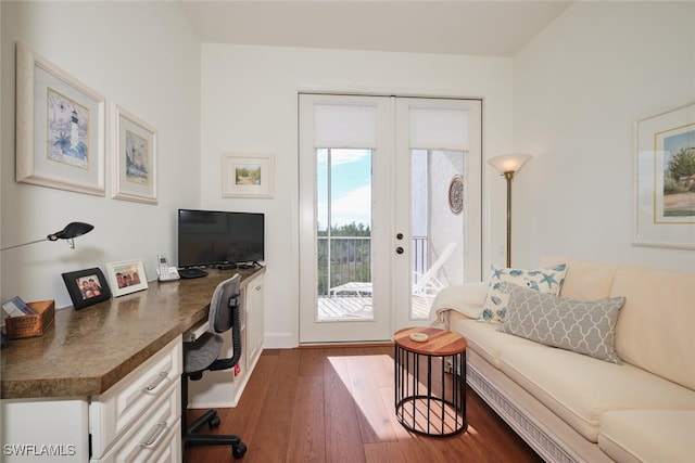 office with dark wood-type flooring and french doors