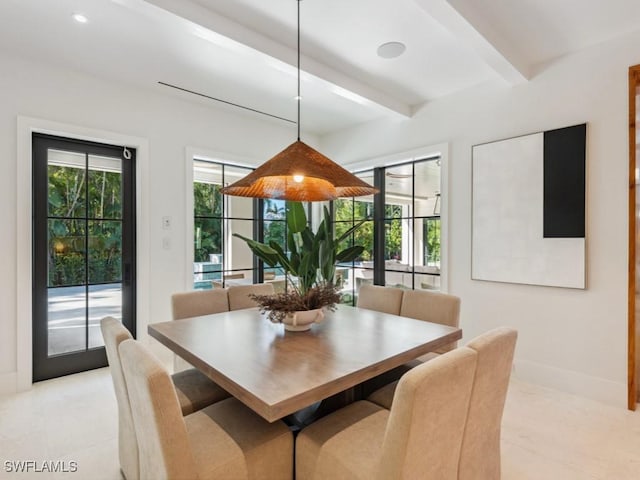 dining space featuring beamed ceiling