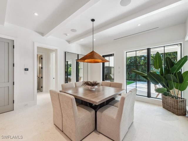 dining space featuring beamed ceiling