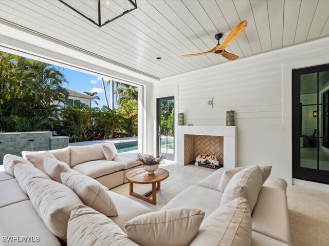 living room with wood ceiling and ceiling fan