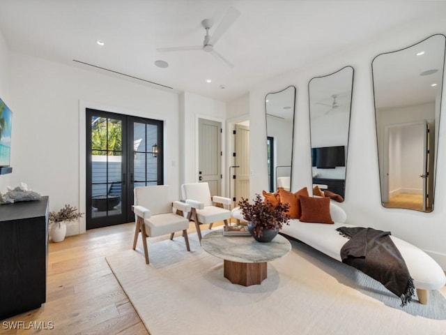 living room with light hardwood / wood-style floors, french doors, and ceiling fan