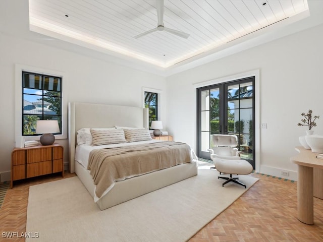 bedroom featuring a tray ceiling, access to outside, wooden ceiling, french doors, and light parquet flooring