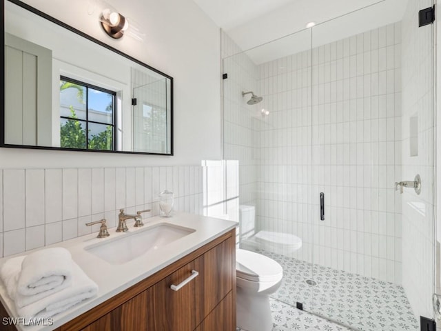 bathroom featuring vanity, an enclosed shower, and toilet