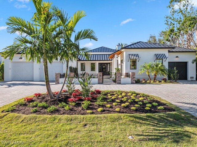 view of front of property featuring a garage and a front lawn