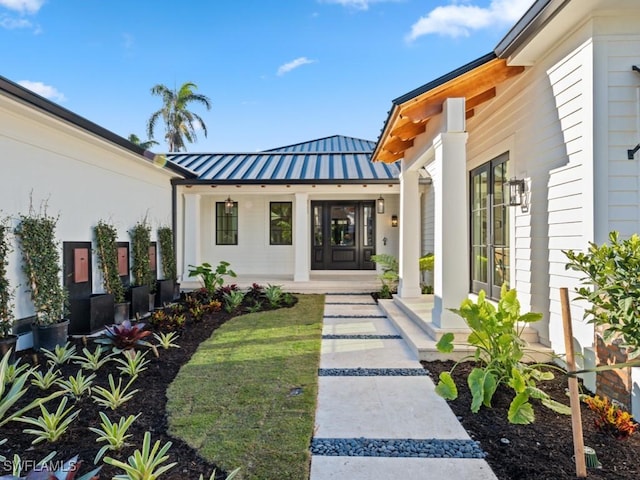 view of exterior entry with covered porch