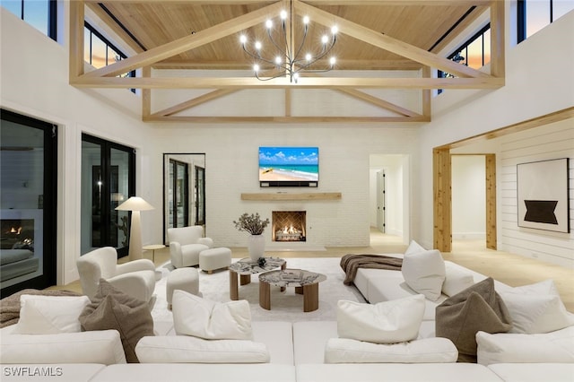 living room featuring wood ceiling, a towering ceiling, an inviting chandelier, and beamed ceiling