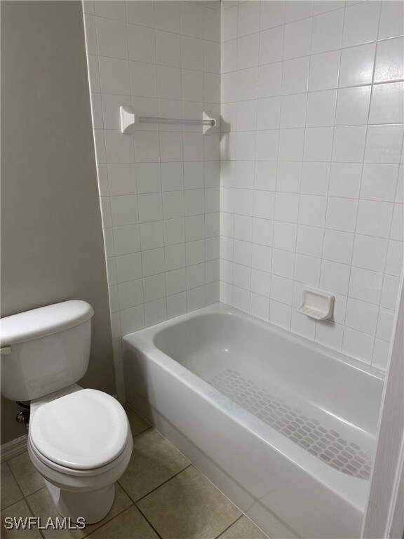 bathroom with toilet and tile patterned flooring