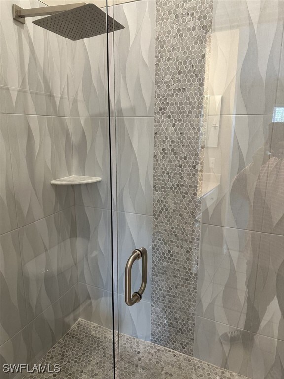 bathroom featuring a shower with door