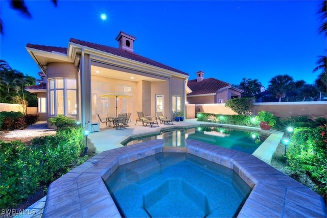 view of pool featuring an in ground hot tub and a patio