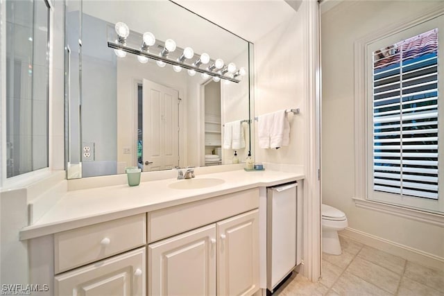 bathroom featuring tile patterned flooring, vanity, and toilet