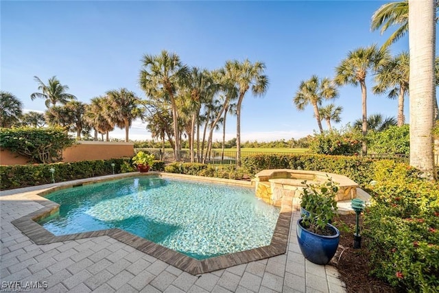 view of swimming pool featuring an in ground hot tub