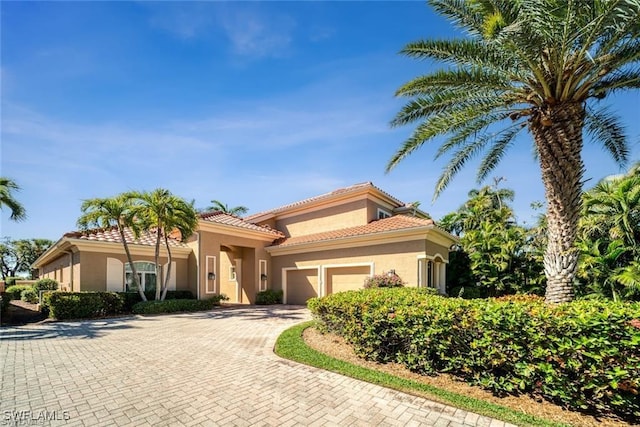 mediterranean / spanish house with a garage