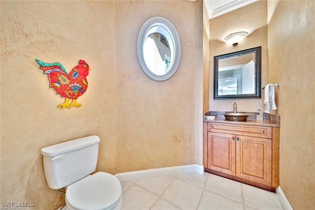 bathroom featuring tile patterned flooring, vanity, and toilet