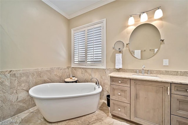 bathroom with crown molding, vanity, a bathtub, and tile walls