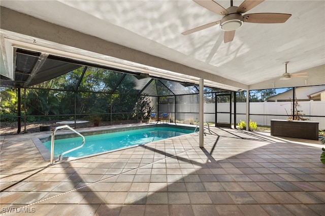 view of swimming pool with a fenced in pool, a patio, glass enclosure, a fenced backyard, and ceiling fan