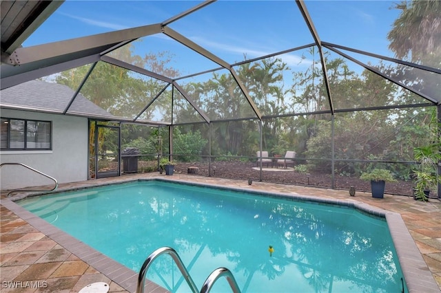 pool featuring a lanai and a patio area