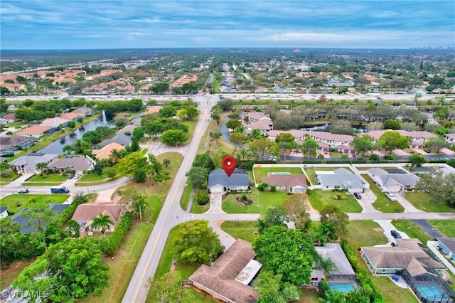 drone / aerial view featuring a residential view and a water view