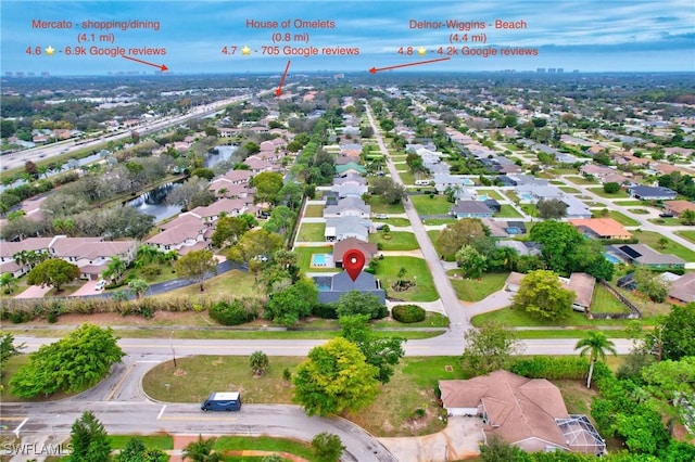 bird's eye view featuring a water view and a residential view