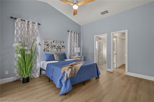 bedroom with light wood-style floors, visible vents, vaulted ceiling, and baseboards