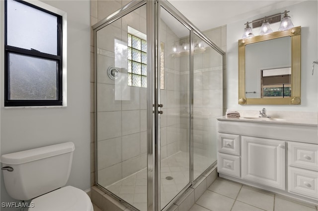 bathroom featuring toilet, a stall shower, tile patterned floors, and vanity