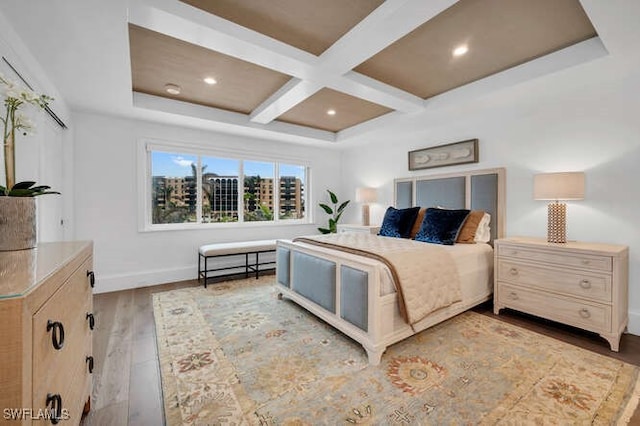 bedroom featuring coffered ceiling, beam ceiling, and light wood-type flooring