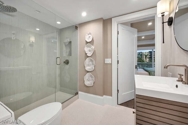 bathroom featuring vanity, toilet, and walk in shower