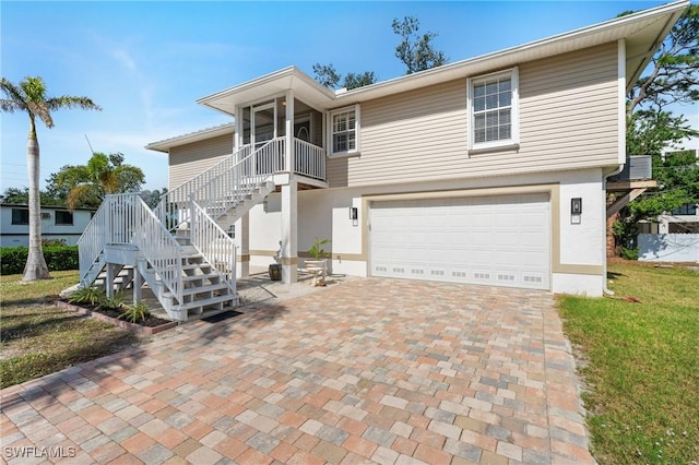 view of front of property featuring a garage and a front yard