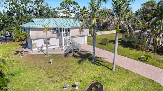 view of front of house with a front yard and a garage