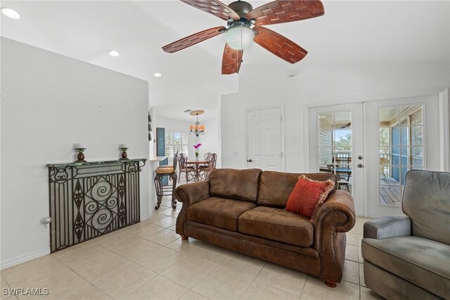 tiled living room with vaulted ceiling, ceiling fan, and french doors