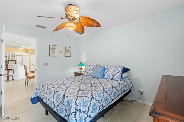 tiled bedroom with ceiling fan and white fridge with ice dispenser