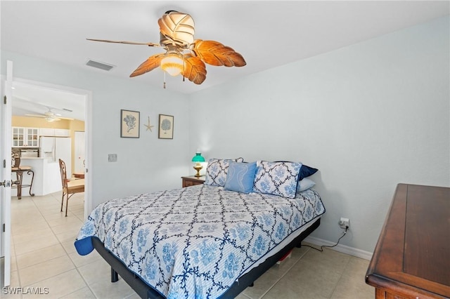 bedroom featuring white refrigerator with ice dispenser, ceiling fan, and light tile patterned floors