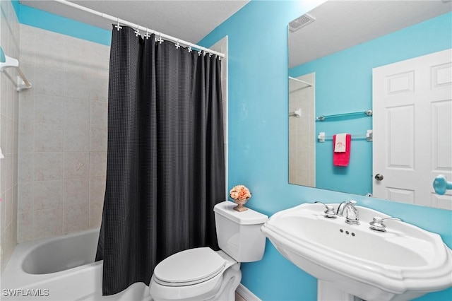 full bathroom featuring toilet, shower / bathtub combination with curtain, and sink