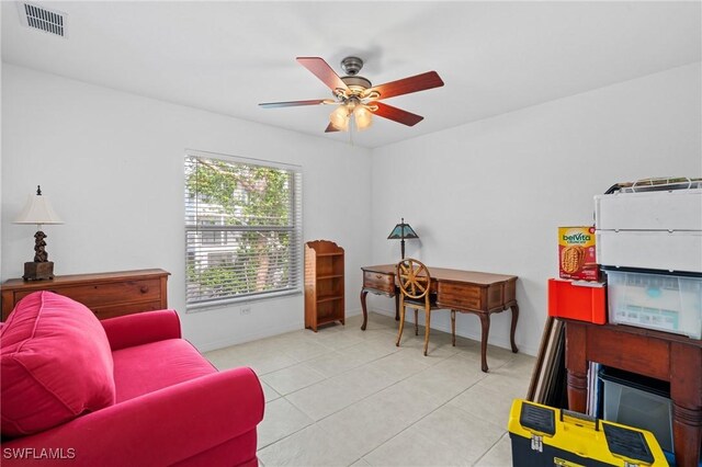 living area featuring light tile patterned flooring and ceiling fan