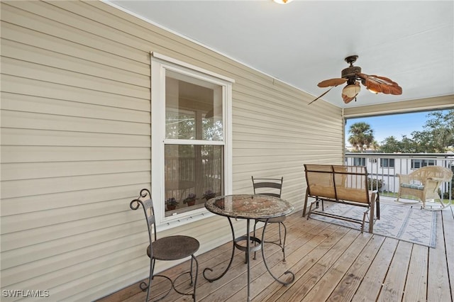 wooden terrace featuring ceiling fan