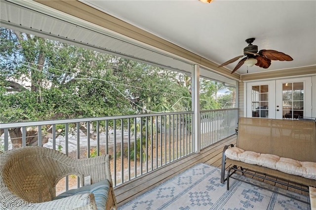 sunroom / solarium featuring a healthy amount of sunlight, ceiling fan, and french doors