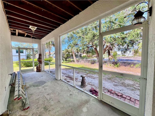 unfurnished sunroom with vaulted ceiling