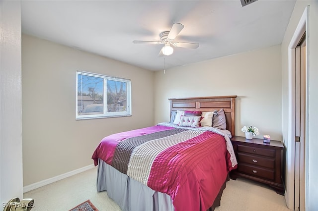 bedroom with ceiling fan and light carpet