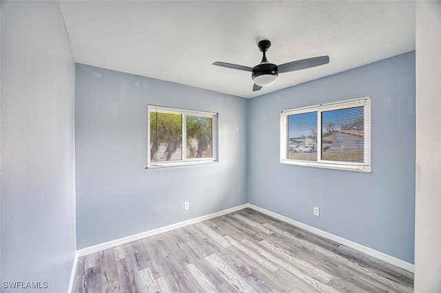 spare room featuring ceiling fan and light hardwood / wood-style floors