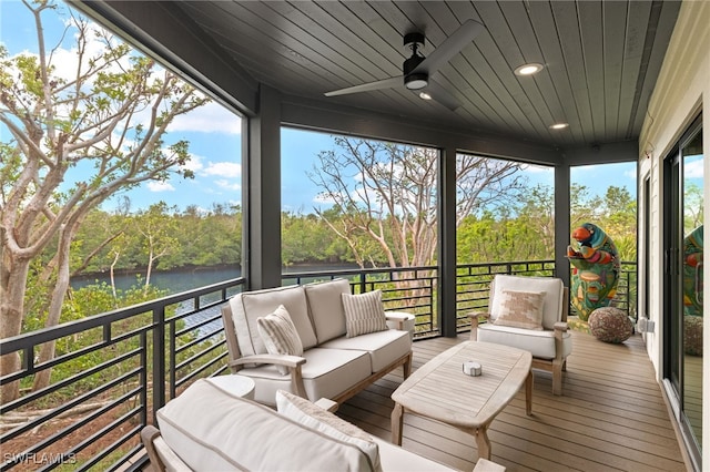 sunroom / solarium with a water view, ceiling fan, and wooden ceiling