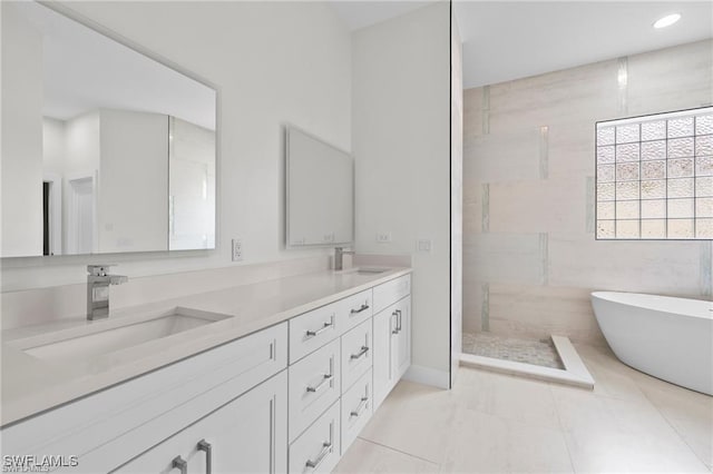 bathroom with vanity, tile patterned floors, and plus walk in shower