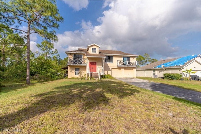 view of front of house featuring a garage and a front lawn