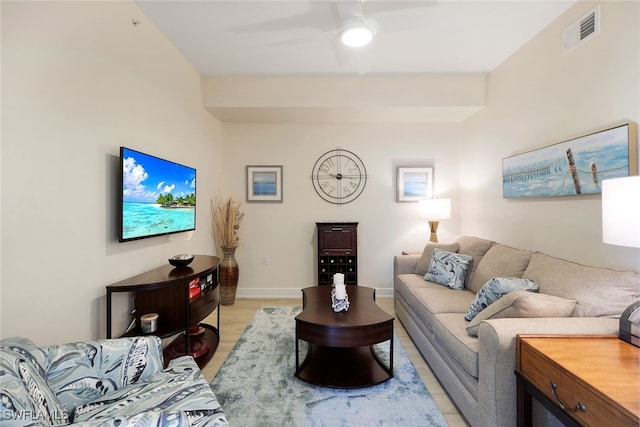 living room featuring ceiling fan and light hardwood / wood-style floors