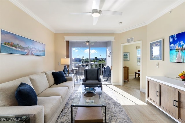 living room with crown molding, ceiling fan, and light hardwood / wood-style flooring